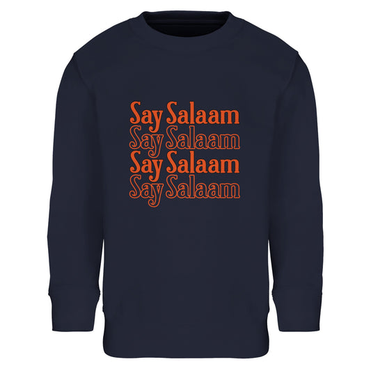 Say Salaam 4-Line Part-Recycled Cotton-Poly Kids Sweatshirt – French Navy / Dark Navy. Youth Islamic sweatshirt with a centred four-line stacked “Say Salaam” print. The rectangular text block uses warm orange lettering with subtle tonal layering, standing out strongly against the deep navy background. The horizontal repetition creates a rhythmic, balanced composition reminiscent of vintage slogan graphics, blending Muslim identity with classic streetwear design in a cheap, high quality jumper.