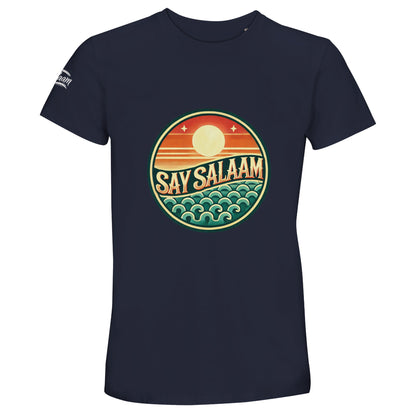 Say Salaam Sunset Glow 50% Recycled Unisex Cotton T-Shirt in French Navy, a deep navy tone close to ebony clay with rich midnight undertones. The warm sunset badge glows against the dark base, combining layered horizon stripes and stylised ocean waves in vintage-inspired colourways. Crafted from 100% cotton using 50% recycled cotton fibres for breathable durability. A versatile crew neck tee suited to football supporters, casual Friday wear and modest everyday fashion.