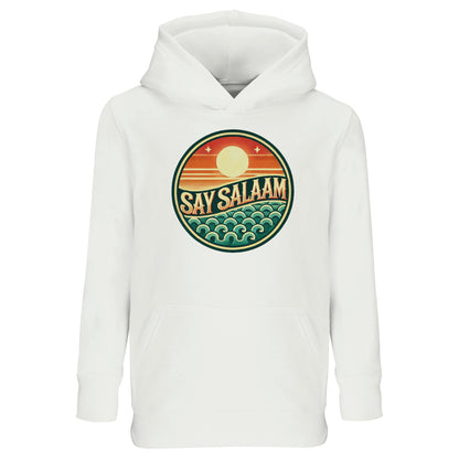 Say Salaam Sunset Glow Part-Recycled Cotton-Poly Kids Hoodie in White, a crisp white tone comparable to platinum white with a clean bright finish. Features the bold circular Sunset Glow badge on the chest, showcasing a rising sun over layered horizon stripes and stylised ocean waves in warm orange, deep red and teal green. Made from a cotton and recycled polyester blend with brushed fleece lining for warmth. Relaxed fit allows easy movement for school, mosque visits and everyday modest streetwear.