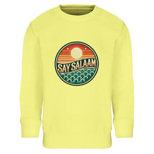 Say Salaam Sunset Glow Part-Recycled Cotton-Poly Kids Sweatshirt in Light Yellow, a soft pastel tone similar to lemon chiffon with bright sunny warmth. The bold circular Sunset Glow emblem features sun, horizon and wave in retro sunset colours, creating a vibrant contrast against the yellow base. Crafted fromcotton and recycled polyester with brushed fleece lining for comfort in cooler weather. A cheerful modest kids sweatshirt perfect for football fans, weekend wear and positive Muslim identity styling.
