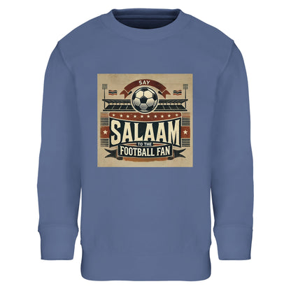 Say Salaam to the Football Fan Design #11 Part-Recycled Cotton-Poly Kids Sweatshirt – Blue / Waikawa Grey featuring bold matchday print in muted red, black, and tan with a stadium, flags, fans and ‘Salaam’. Hoodie alternative for young fans who watch football goals and stream UEFA nights, EPL weekends and Saudi League drama. Children’s football jumper, boys or girls sweatshirt, modest youth streetwear, pullover for halftimes and post-match celebrations, streaming or to find a “football academy near me”.
