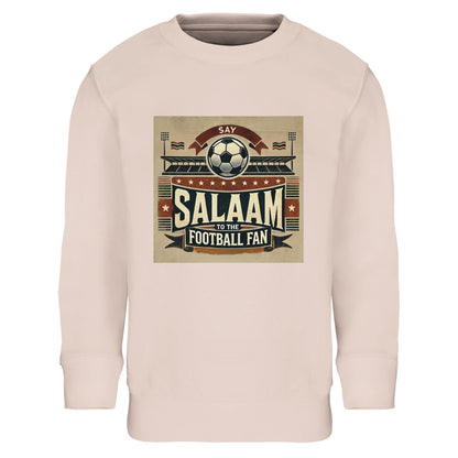 Say Salaam to the Football Fan Design #11 Part-Recycled Cotton-Poly Kids Sweatshirt – Creamy Pink / Oyster Pink featuring classic matchday artwork in tan, red and black with flags, a stadium and big ‘Salaam’ print. Soft-toned football sweatshirt for youngsters who track goals in the Champions League, weekend games in the EPL, or Saudi Pro League transfers. Modest streetwear pullover for girls, boys, or unisex – a sporty graphic top made for little football fans of all kinds in the stadium or streaming.