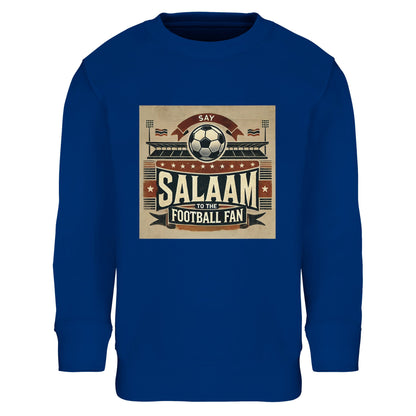Say Salaam to the Football Fan Design #11 Part-Recycled Cotton-Poly Kids Sweatshirt – Royal Blue / Dark Midnight featuring retro football art in black, red and tan with flags, fans, stadium and bold ‘Salaam’. A youth basic graphic pullover for true supporters who follow Premier League, UCL, La Liga, Ligue 1, Bundesliga, Qatar Stars League or Saudi Pro League action. Boys’ sweatshirt, girls’ jumper, or unisex long sleeve top for modest fashion football fanatics who love kits, goals, chants and controversy.