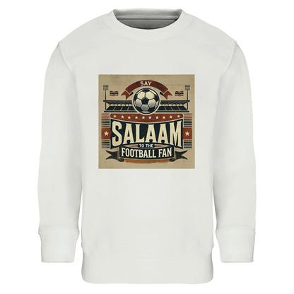 Say Salaam to the Football Fan Design #11 Part-Recycled Cotton-Poly Kids Sweatshirt – White / Platinum featuring retro matchday-style artwork in tan, black, and red with flags, fans, a stadium and ‘Salaam’ lettering. A football jumper for youngsters who stream Premier League and Champions League, know every VAR call and Saudi League result. Graphic pullover, modest sportswear, youth fan fashion for future strikers, defenders and diehard supporters. Long sleeve tee for boys, girls, or unisex.