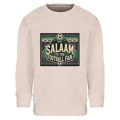 Say Salaam to the Football Fan Design #8 kids sweatshirt – Creamy Pink / Oyster Pink pairing bold football lettering with illustrated stadium crowds, footballs and pitch lines. The soft pink tone offers a gentle contrast to the energetic matchday artwork, great for kids who like colour with comfort. Designed for ages four to fourteen, suitable for school, everyday wear or relaxed football moments. A warm, modern football jumper that celebrates personality and Salaam.