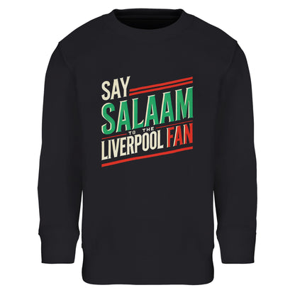 Say Salaam to the Liverpool Fan Design #1 Part-Recycled Cotton-Poly Kids Sweatshirt – Black / Deep Black featuring bold retro typography in green, cream, and red. The design captures football pride and faith in one clean graphic that reads ‘Say Salaam to the Liverpool Fan’. Made from an 80% cotton, 20% recycled polyester blend with soft brushed fleece lining, this kids’ jumper brings together modest comfort, sustainability, and Scouse energy — ideal for matchday layering or quiet prayer evenings.