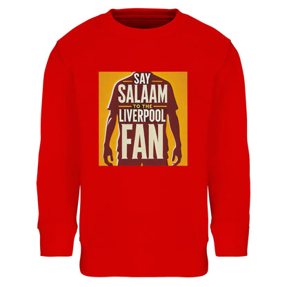 Say Salaam to the Liverpool Fan Design #3 Kids Sweatshirt – Bright Red / Matchday Scarlet featuring a gold-panelled print with the silhouette of Mo Salah standing proud under the words ‘Say Salaam to the Liverpool Fan’. Combining 80% cotton with 20% recycled polyester, this soft fleece sweatshirt keeps faith and football front and centre. For Muslim kids who celebrate Salah’s spirit — prayerful, humble, and relentless — it’s an everyday symbol of belief, belonging, and the love of the game.