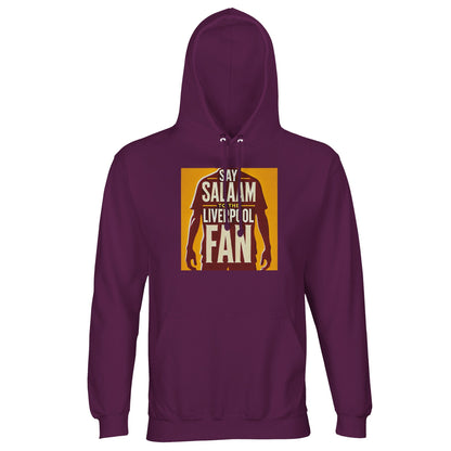 Say Salaam to the Liverpool Fan Design #3 Part-Recycled Unisex Cotton-Poly Hoodie – Astral Purple / Deep Maroon featuring a golden print with a red silhouette of a player and Liverpool-themed text. This sustainably made hoodie merges comfort and conscience with contemporary style. Soft brushed fleece adds warmth while the design reflects solidarity across stadiums and cities — a subtle fusion of passion, peace, and pride that echoes the word ‘Salaam’.