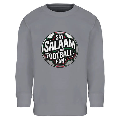 Say Salaam to the Football Fan Design #1 Part-Recycled Cotton-Poly Kids Sweatshirt – Grey Melange / Heather Grey. Kids Islamic football sweatshirt featuring a symmetrical circular badge print with black and charcoal pitch tones, green accents and white lettering. Subtle red lines and floodlight glow effects give depth to the round emblem. Classic athletic aesthetic meets stadium-inspired design for Muslim youth players and supporters.