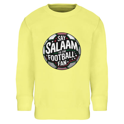 Say Salaam to the Football Fan Design #1 Part-Recycled Cotton-Poly Kids Sweatshirt – Light Yellow / Lemon. Youth Islamic football sweatshirt featuring a circular football crest graphic with dark pitch tones and layered green, black and white text. The round badge structure, enhanced by subtle red detailing and stadium glow, gives a vibrant, energetic feel. Ideal for school tournaments, youth academies and little fans who celebrate goals with salaam.