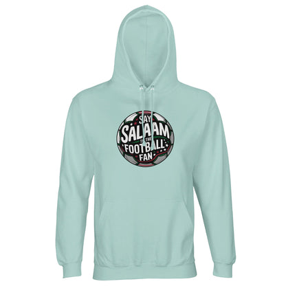 Arctic Blue / Cadet Blue unisex hoodie displaying the Say Salaam to the Football Fan Design #1 circular crest design. The rounded football badge graphic features deep black and green pitch tones, subtle red highlights and illuminated stadium beams radiating behind the text. Its symmetrical badge shape and strong contrast create a classic supporter aesthetic with a confident competitive mood. Muslim football apparel that blends Islamic identity with club culture, grassroots matches and global tournaments.