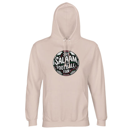 Creamy Pink / Oyster Pink Islamic unisex hoodie showcasing the Say Salaam to the Football Fan Design #1 circular football crest. The design uses a round badge format with charcoal and green pitch tones, white central lettering and stadium light beams radiating outward. The symmetrical composition and strong outline give it a confident club badge feel with a positive, inclusive tone. Muslim football fan clothing that blends Islamic greetings with competitive matchday energy.