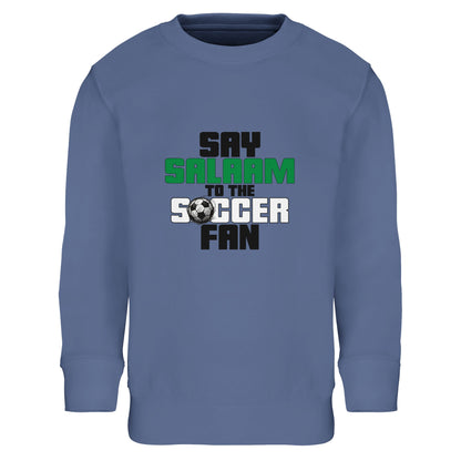 Say Salaam to the Soccer Fan Original Part-Recycled Cotton-Poly Kids Sweatshirt – Blue / Denim Blue. Kids Islamic soccer sweatshirt with a centred stacked typography graphic in bold black and green. The strong vertical layout and compact football icon detail give the design a sharp, sporty structure reminiscent of team slogans and stadium signage. Cool blue tone complements the modern athletic feel, perfect for youth leagues and after-school football.