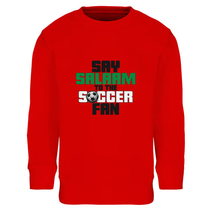 Say Salaam to the Soccer Fan Original Part-Recycled Cotton-Poly Kids Sweatshirt – Bright Red / Rosso Red. Kids Muslim soccer sweatshirt with a powerful stacked typographic design in black and green, centred for maximum visibility. The layered vertical layout creates a dynamic, energetic feel, echoing scoreboard graphics and team branding. Strong contrast against the red background gives a matchday-ready vibe, ideal for young football supporters expressing Islamic identity through sport.