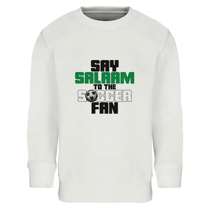 Say Salaam to the Soccer Fan Original Part-Recycled Cotton-Poly Kids Sweatshirt – White / Platinum. Kids Islamic soccer sweatshirt featuring a bold stacked typographic graphic centred on the chest. The design uses strong block lettering in black and deep green with a small football icon. “Say Salaam” appears prominently above “Soccer Fan” in a clean vertical composition, creating a modern streetwear feel. Crisp contrast against the white base gives it a sharp, confident tone for playgrounds.