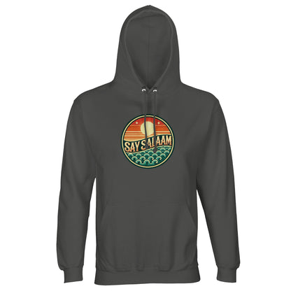 Charcoal Melange / Black Cow unisex hoodie featuring the Say Salaam Sunset Glow circular skyline print in warm orange and teal tones. The deep marl base enhances the vibrancy of the sunset gradient, allowing the round chest badge to glow with strong contrast. Layered waves and horizon lines create depth within the circular composition. Ideal for modest Islamic streetwear, this hoodie delivers faith-based fashion, comfort and everyday durability.