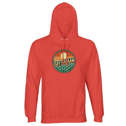 Pop Orange / Jasper unisex hoodie showcasing the Say Salaam Sunset Glow circular emblem with layered skyline and wave detailing. The warm orange base intensifies the rich sunset gradient within the round chest badge, creating bold tonal harmony and standout streetwear presence. The centred circular graphic delivers symmetry and strong focal structure. Crafted for modest Islamic fashion, this hoodie combines brushed fleece comfort, faith-led identity and expressive Muslim street style.