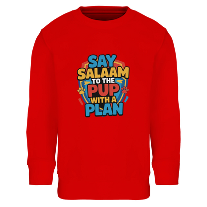 Say Salaam to the Pup with a Plan Part-Recycled Cotton-Poly Kids Sweatshirt (Bright Red / Rosso Corsa). Kids jumper featuring a colourful square illustration panel and a slogan printed across the chest. The playful graphic shows bold cartoon lettering combined with a lively rescue-pup themed illustration inspired by adventurous puppy hero teams enjoyed by Paw Patrol Movie fans. Soft cotton-poly fleece with recycled fibres offers warmth and durability for everyday clothing with character. 