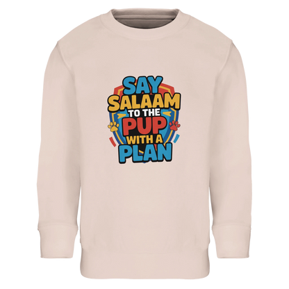 Say Salaam to the Pup with a Plan Part-Recycled Cotton-Poly Kids Sweatshirt (Creamy Pink / Oyster Pink). Kids jumper featuring a colourful square illustration panel and a slogan printed across the chest. The playful graphic combines bold cartoon lettering with a cheerful rescue-pup themed design inspired by adventurous animated puppy teams popular with Paw Patrol fans. Soft cotton-poly fleece with recycled fibres ensures warmth, comfort and durability for everyday wear. The design is appealing for children.