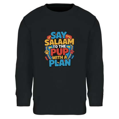 Say Salaam to the Pup with a Plan Part-Recycled Cotton-Poly Kids Sweatshirt (Deep Black / Zeus). Kids jumper featuring a colourful square illustration panel and a slogan printed across the chest. The playful graphic blends bold cartoon lettering with a cheerful rescue-pup themed illustration inspired by animated puppy hero teams popular with Paw Patrol Movie fans. Soft cotton-poly fleece fabric containing recycled fibres provides warmth and durability for everyday wear. 