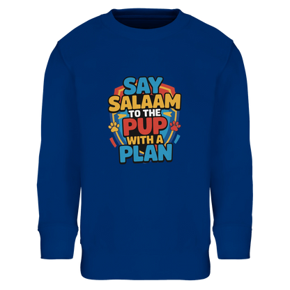 Say Salaam to the Pup with a Plan Part-Recycled Cotton-Poly Kids Sweatshirt (Royal Blue / Dark Midnight Blue). Kids jumper featuring a colourful square illustration panel and a slogan printed across the chest. The playful graphic combines bold cartoon lettering with a lively rescue-pup themed illustration inspired by adventurous animated puppy teams loved by Paw Patrol characters fans. Soft cotton-poly fleece fabric with recycled fibres ensures warmth and durability for everyday clothing. 